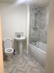 a bathroom with a toilet and a sink and a shower at 27 William Jessop Way Bristol BS13 0RL in Whitchurch