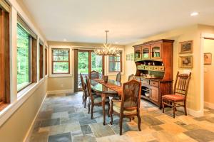 a dining room with a table and chairs at Sugar Berry-Remodeled Laughlintown Craftsman Home! in Laughlintown