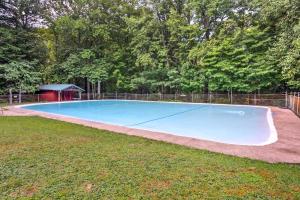 a large blue swimming pool in a yard at Sugar Berry-Remodeled Laughlintown Craftsman Home! in Laughlintown