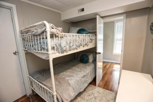 Etagenbett in einem Zimmer mit Spiegel in der Unterkunft Adorable 2-bedroom guest house with free parking in Galveston