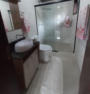 a bathroom with a toilet and a sink and a shower at Tiny House Canjerana- Morro do Eurico - Praia Grande-SC in Praia Grande