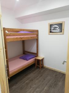 Zimmer mit einem Etagenbett und einem Tisch in der Unterkunft Chalet Les Garands in Valmeinier