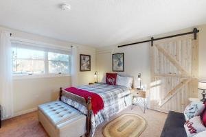 a bedroom with a bed and a sliding barn door at Dream Weaver in Ludlow