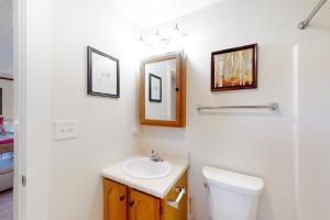 a white bathroom with a toilet and a sink at Dream Weaver in Ludlow