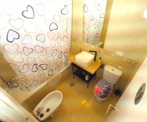 a small bathroom with a toilet and a sink at Apartamento en el centro para 4 personas in Seville +22 photos