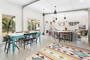 a living room with a blue table and chairs at Sojourne in Shoalhaven Heads