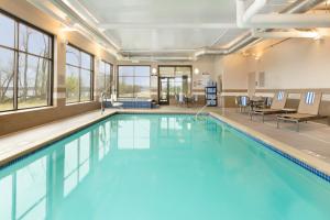 a swimming pool with blue water in a building at Country Inn & Suites by Radisson, Bemidji, MN in Bemidji