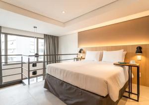 Cozzy Suites Paraíso Hotel客房内的一张或多张床位