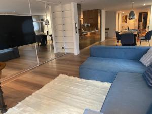 a living room with a blue couch and a television at Luxury apartment (Porta Venezia) in Milan