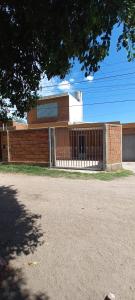 a brick building with a gate in front of it at Departamento Silvi in Jesús María