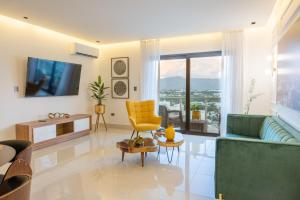 a living room with a couch and a tv at Top Floor in Luxury Tower in Santiago de los Caballeros