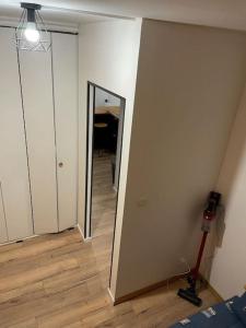 a room with a hallway with a mirror and a lamp at Pra-loup 1600 in Uvernet-Fours