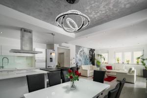 a kitchen and living room with a table and chairs at Villa Palladium in Makarska