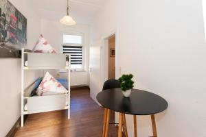a small room with a table and a bunk bed at Apartment Zoey in Auerbach