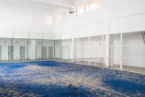 an empty tennis court with a net at Luxury Duplex with Pool and Padel Court in Town by AlohaMálaga in Málaga