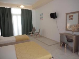 a room with a bedroom with a desk and a bed at Katerina Apartments near the Sea in Zakynthos Town