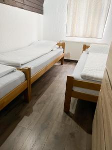 a room with two beds and a window at Holiday Home Aleksandar Brzece Kopaonik in Brzeće