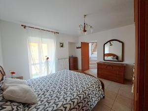 Schlafzimmer mit einem Bett, einer Kommode und einem Spiegel in der Unterkunft Emily's House in San Buono