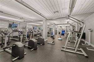 a gym with several treadmills and cardio machines at Luxury Beachfront Family-Friendly Condo in Hollywood