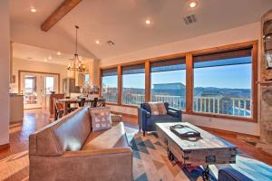 a living room with a couch and a table at Updated Cabin with 360-Degree Mtn View 1 Mi to Lake in Medicine Park