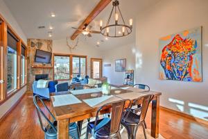 a dining room and living room with a table and chairs at Updated Cabin with 360-Degree Mtn View 1 Mi to Lake in Medicine Park