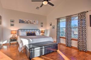 a bedroom with a bed and a ceiling fan at Updated Cabin with 360-Degree Mtn View 1 Mi to Lake in Medicine Park