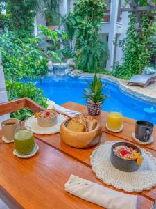 a table with food and drinks on a table in front of a pool at Casita del Mar in Playa del Carmen +40 photos