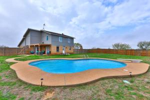 a swimming pool in the yard of a house at Lazy Boho Resort: Roomy Lux. Home w/ Private Pool in Abilene