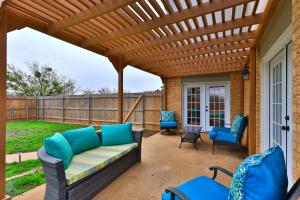 a patio with a couch and chairs under a wooden pergola at Lazy Boho Resort: Roomy Lux. Home w/ Private Pool in Abilene
