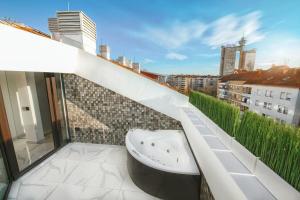 a bathroom with a bath tub on a balcony at Premium spa in Belgrade