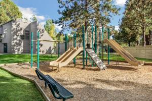 a playground with a slide in a park at Ski House 106 - Meredith Lodging in Bend