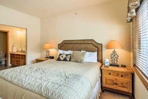 a bedroom with a bed and two lamps and a mirror at Main St Frisco Vacation Rental Near Ski Resorts! in Frisco
