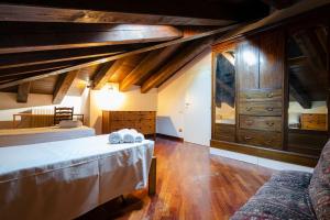 a large room with two beds and a dresser at Griffoni Home, in the Heart of the City in Bologna
