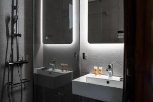 a bathroom with two sinks and a mirror at Pittas Studios in Kardamaina