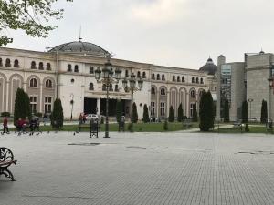 a large building with a courtyard in front of it at Blue Sky in Skopje
