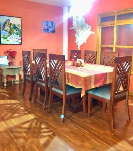 a dining room with a wooden table and chairs at Casa de Alondras in Panajachel