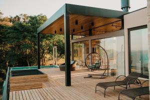 a house with a deck with a swing at Casas na montanha - Villa Montegrappa in Caxias do Sul