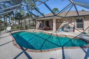 a swimming pool in a house with a glass roof at Naples Oasis in Naples