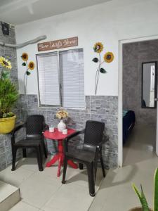 a dining room with a red table and two chairs at Casa Rebecca 39-41 in Cartagena de Indias