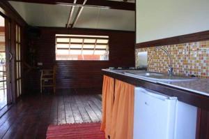 a kitchen with a sink and a counter top at Raiatea Airport Bungalow in Uturoa