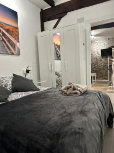 a bedroom with a bed with a black blanket on it at Salabardoa Ea in Ea