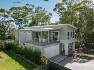 a modular home with a porch and a fence at The Quarterdeck in Callala Bay