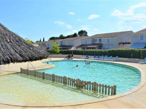a swimming pool with people in the water at Maison duplex avec terrasse, piscine chauffée, 6 pers., Vallon-Pont-d'Arc. - FR-1-382-21 in Vallon-Pont-dʼArc