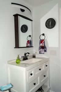 a bathroom with a white sink and a mirror at Queen Bed - Boston - RM 2 in Stoneham