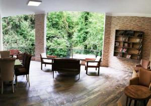 a large living room with a table and chairs at Şelale Otel in Rize