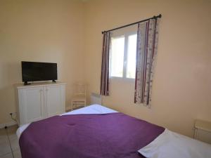 a bedroom with a bed and a tv and a window at Maison 6 pers. avec Terrasse Privée, 3 Pièces en Duplex – Wifi & Animaux Admis - FR-1-382-119 in Grospierres