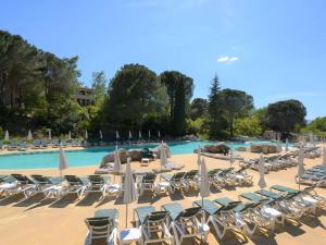 a group of lounge chairs and tables and a swimming pool at Maison 6 pers. avec Terrasse Privée, 3 Pièces en Duplex – Wifi & Animaux Admis - FR-1-382-119 in Grospierres
