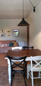 a dining room with a table and chairs and a couch at Podere Campiano in Volterra