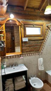 a bathroom with a sink and a mirror at Las Nubes Cabañas in San Carlos de Bariloche