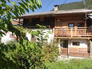 a log cabin with a deck and a porch at Chalet Arêches-Beaufort, 3 pièces, 4 personnes - FR-1-342-220 in Beaufort
